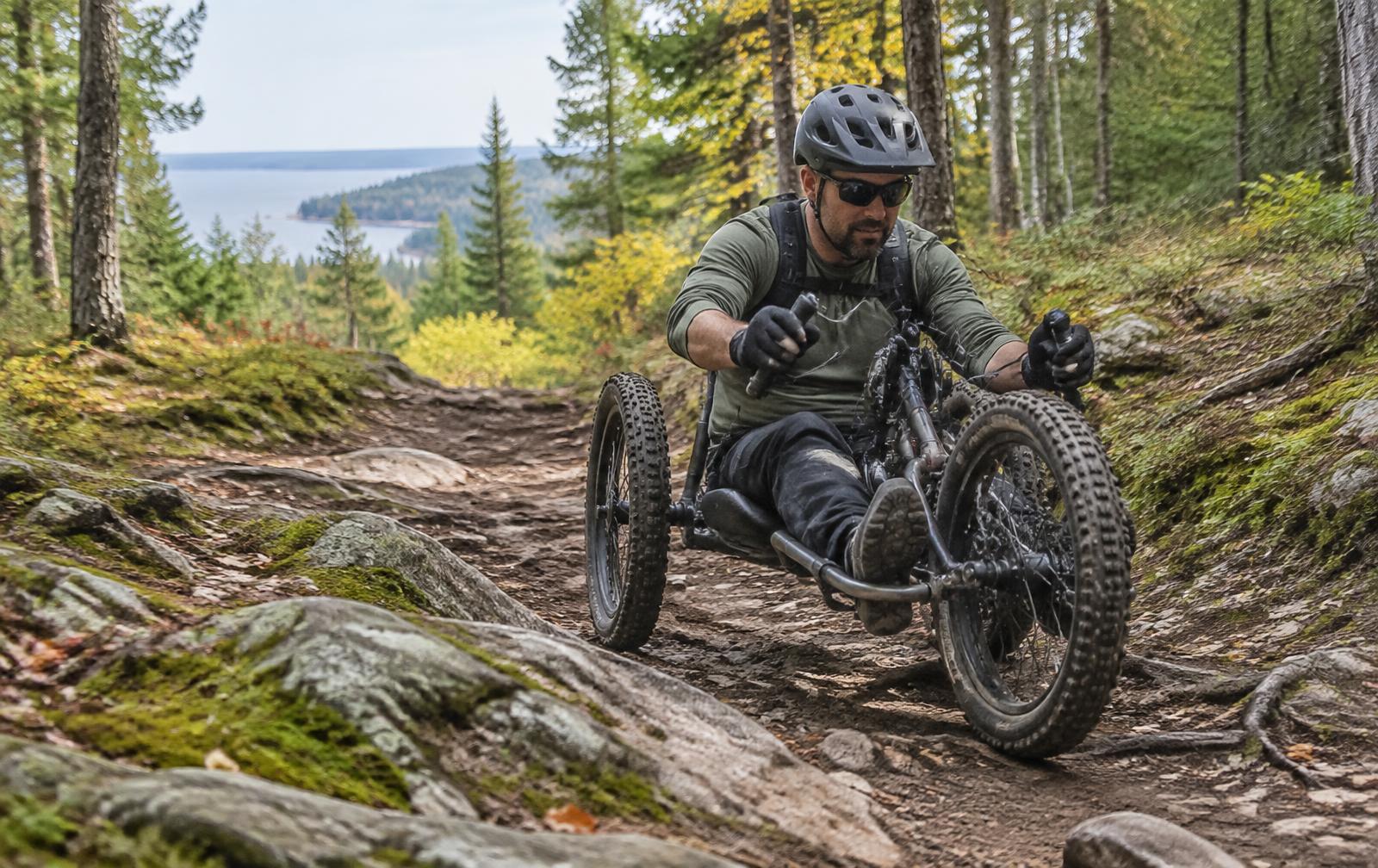An adaptive off-road handcyclist riding a forest trail through Upper Peninsula terrain